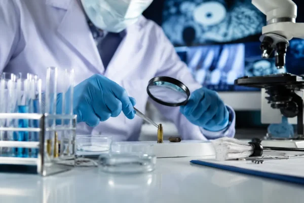 Forensic expert standing in a modern forensic science laboratory for Diploma in Forensic Science course in Madurai, Tamil Nadu, India